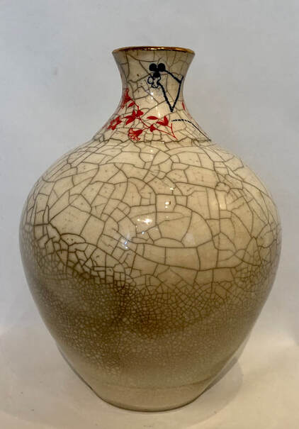 Raku fired vase with painted top and gilded rim