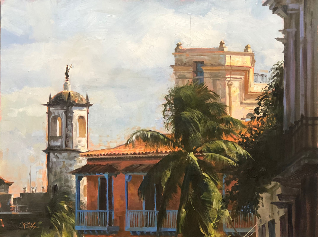 Havana architecture with balconies and palms against cloudy sky