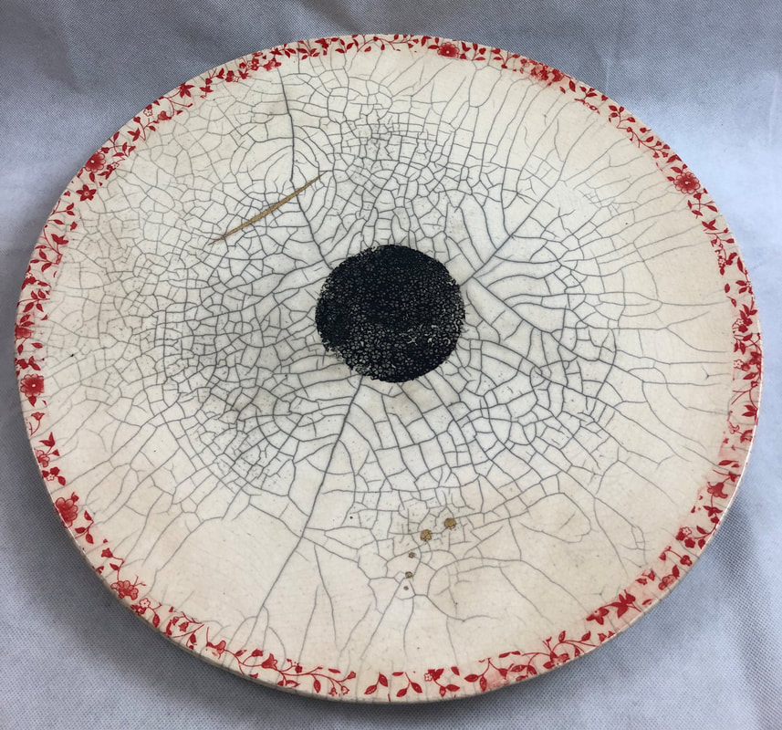 Raku fired ceramic platter with painted rim and center