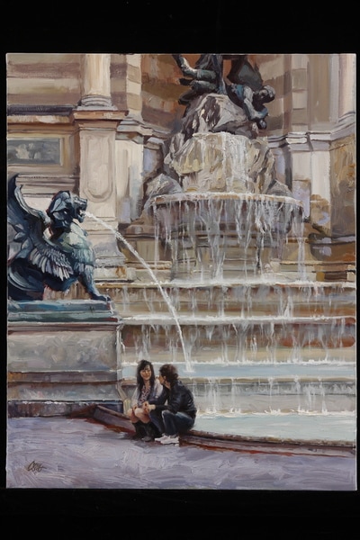 Young couple seated before a fountain