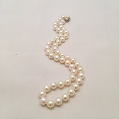 Single strand of white pearls