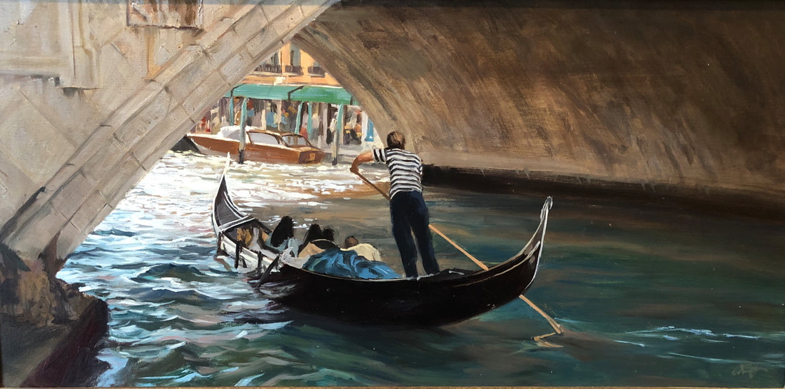 Gondola captain rowing a family under archway