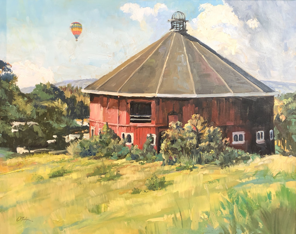 Red barn at Fountain Grove with hot air balloon in the background