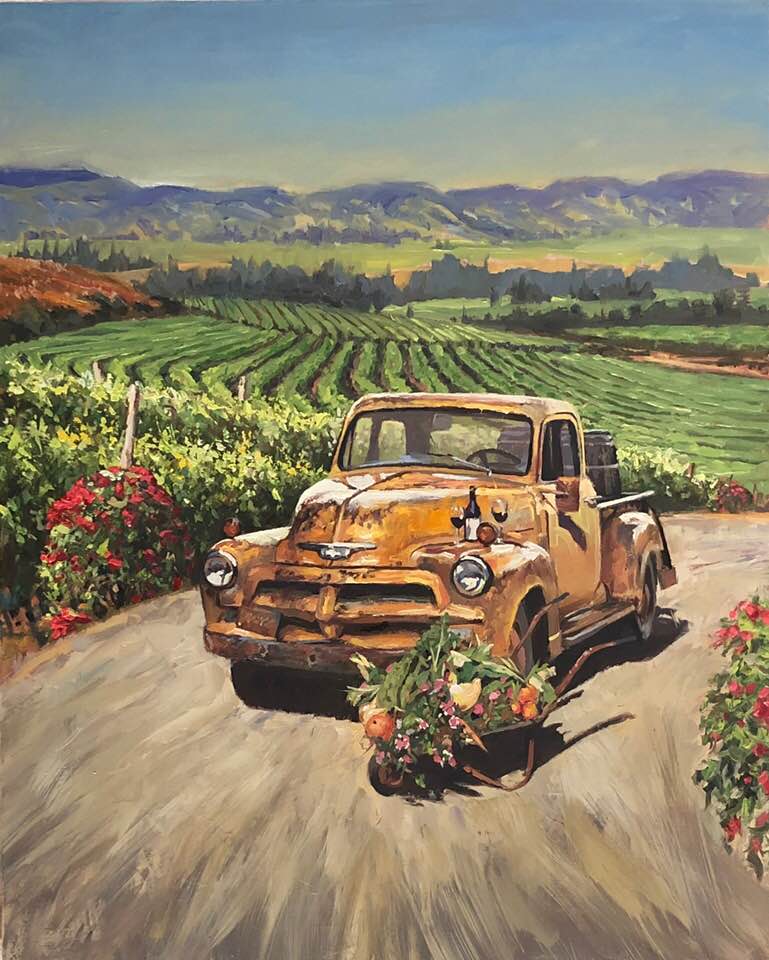 Vintage orange truck with in front of vineyard 