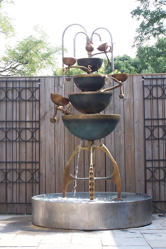 Abstract bronze fountain of cups and chalices