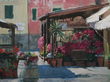 Outdoor cafe with potted flowers and awning