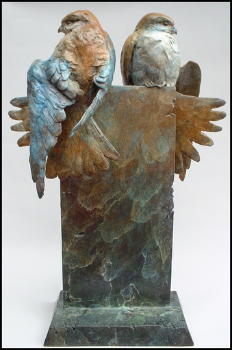 Bronze sculpture of two birds facing away from each other on pedestal