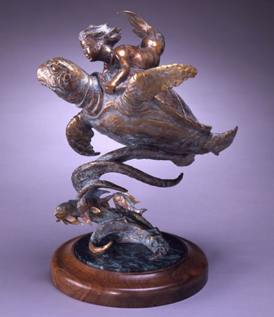 table top bronze of a merbaby riding a sea turtle