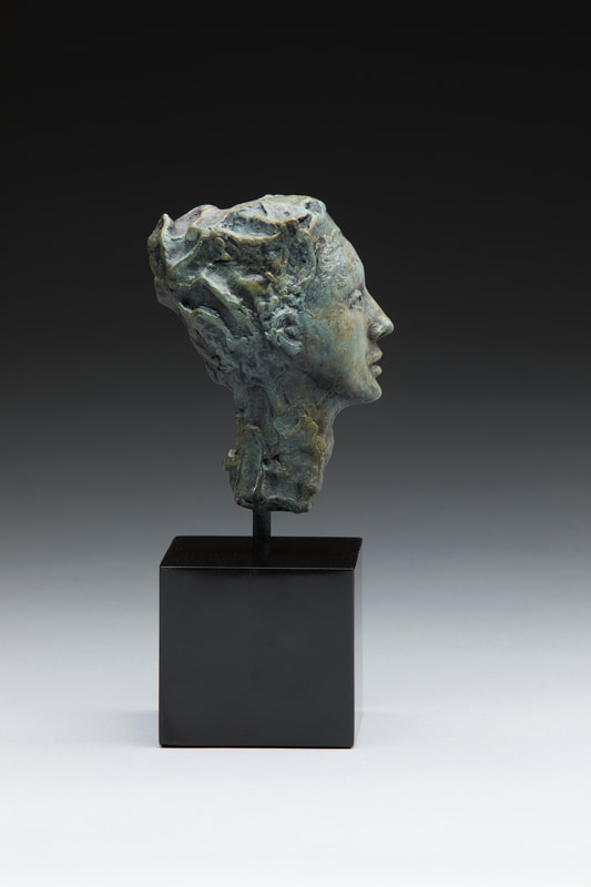 Bronze bust of woman in side view 