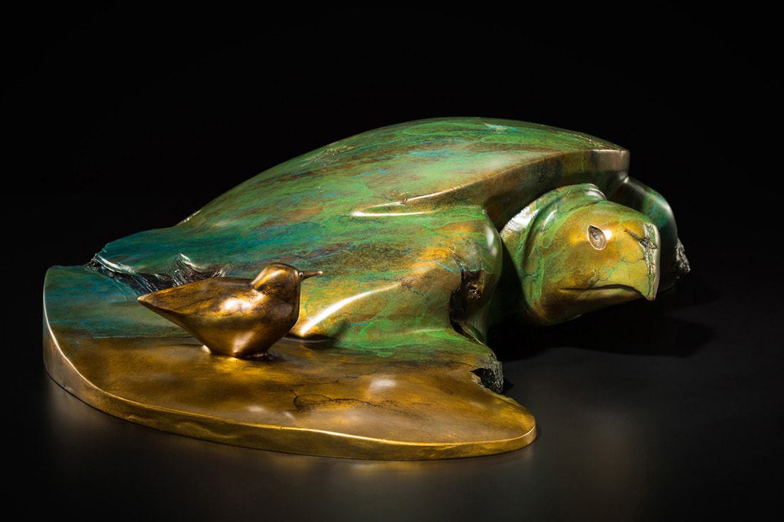 Bronze sculpture of sea turtle with bird