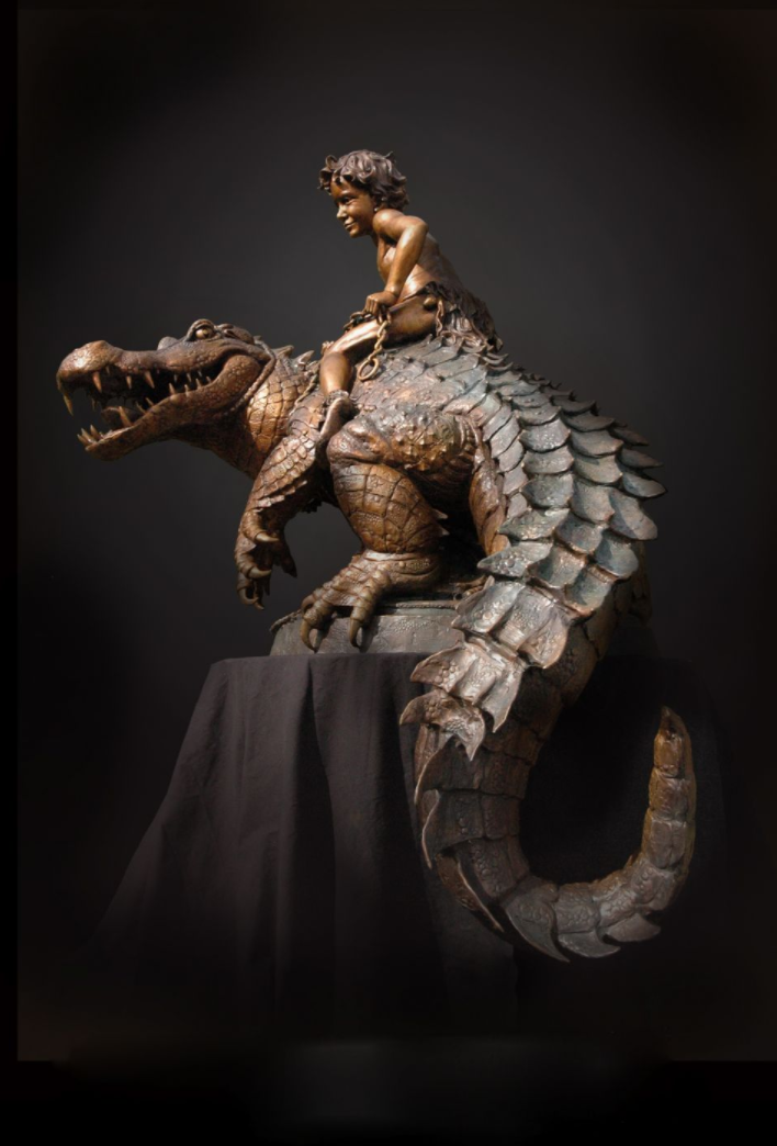 Bronze sculpture of boy riding alligator 