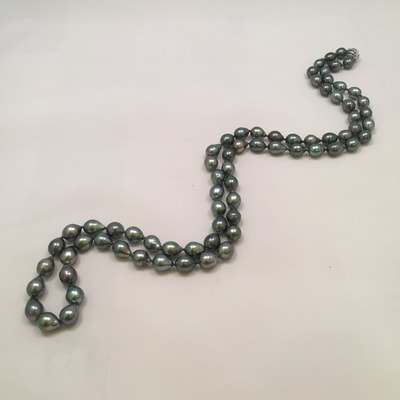 Single strand necklace of black pearls