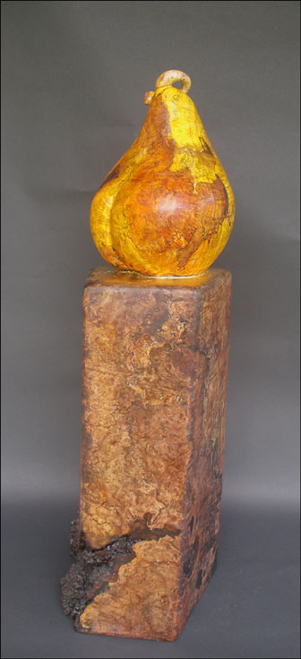 Wood burl sculpture of pear on pedestal 
